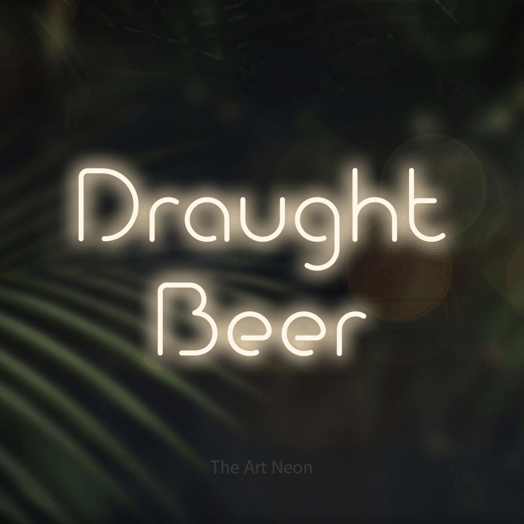 Warm white LED neon sign reading "Draught Beer" against dark blurred palm leaves for bar décor