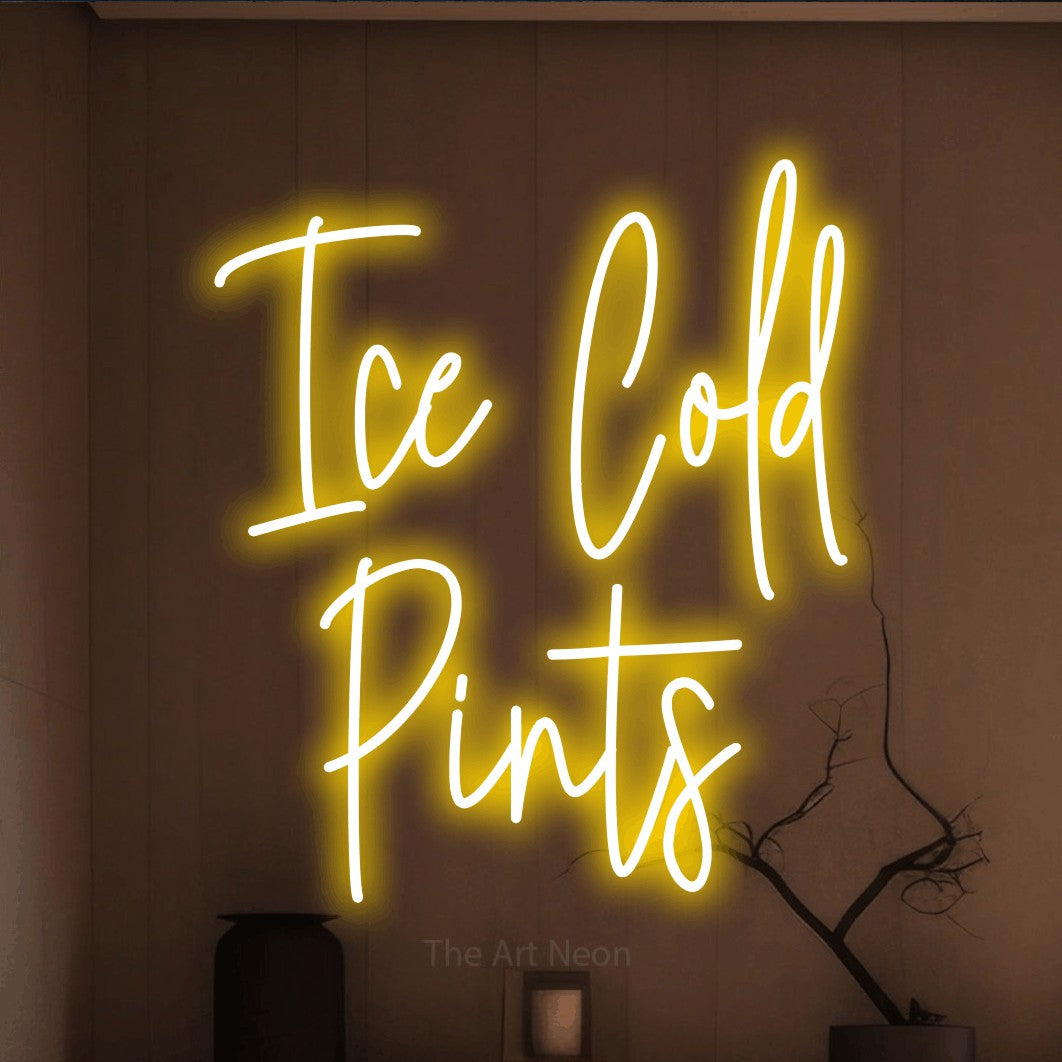 Yellow script-style LED neon sign reading "Ice Cold Pints" against a warm brown wall for bar décor