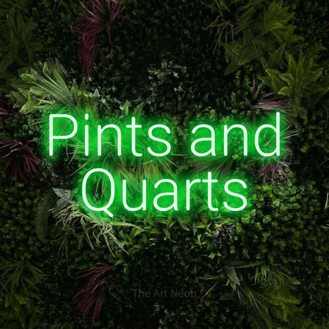Green LED neon sign reading "Pints and Quarts" against a lush garden wall with pink flowers for bar décor
