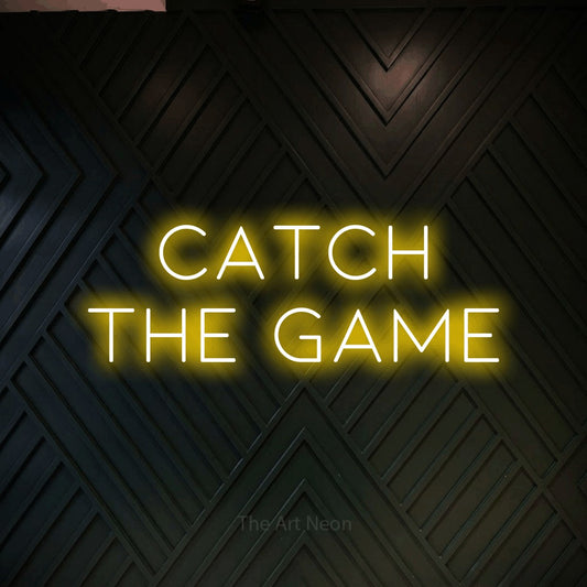 Yellow LED neon sign reading "Catch the Game" against a dark geometric wood wall for bar décor