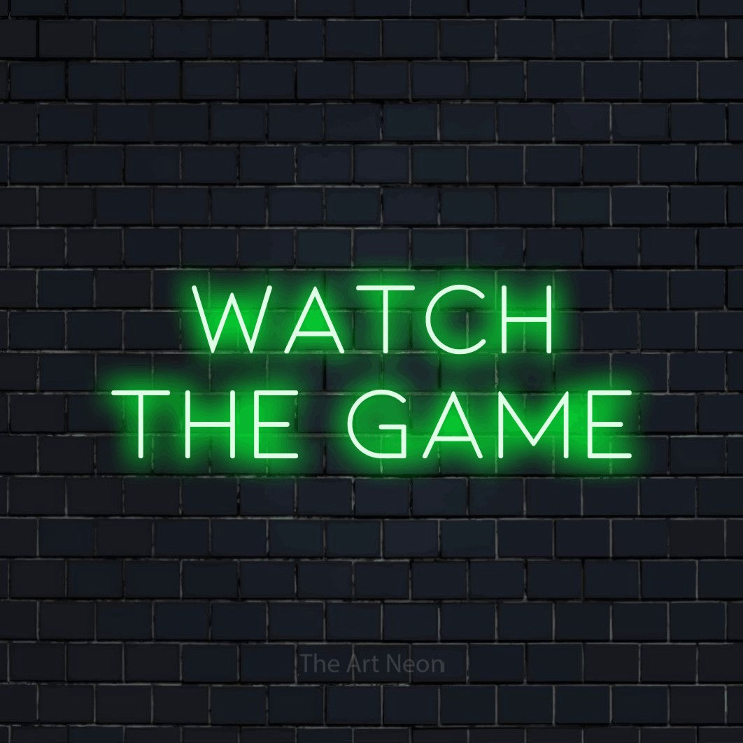 Green LED neon sign reading "Watch the Game" against a dark navy brick wall for bar décor