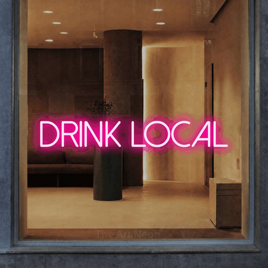 Hot pink LED neon sign reading "Drink Local" in a warm modern interior for bar décor