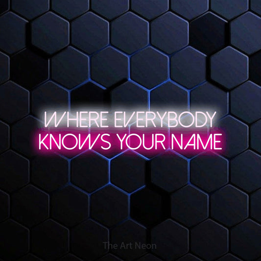 Hot pink and cool white LED neon sign reading "Where Everybody Knows Your Name" against a blue hexagonal wall for bar décor