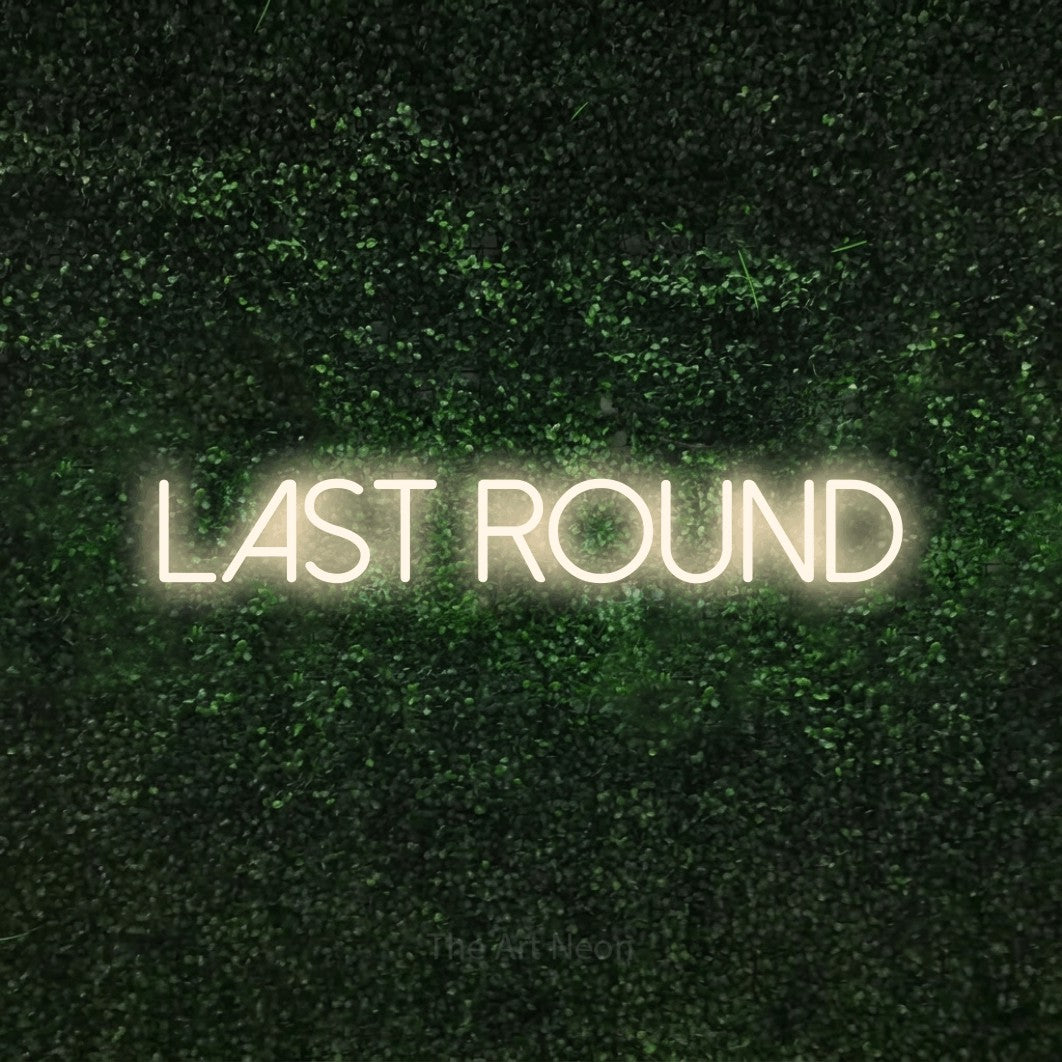 Warm white LED neon sign reading "Last Round" against a textured green moss wall for bar décor