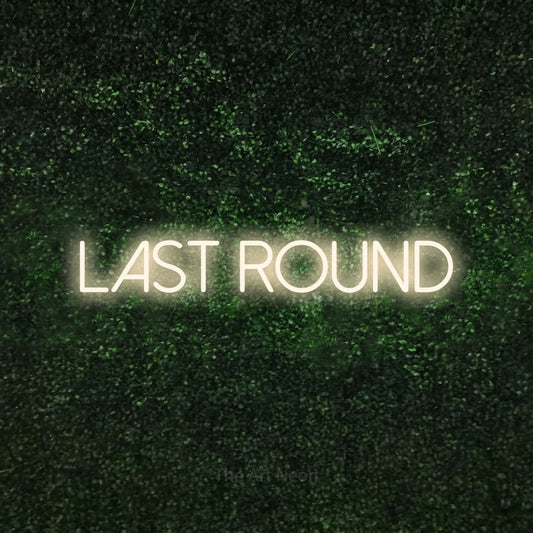 Warm white LED neon sign reading "Last Round" against a textured green moss wall for bar décor