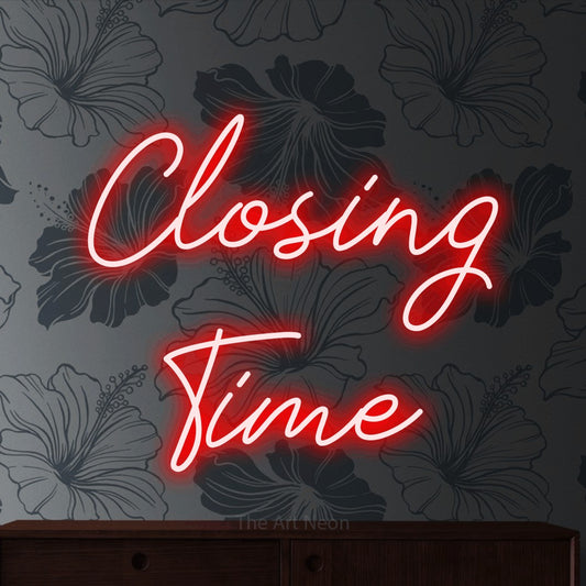 Red script-style LED neon sign reading "Closing Time" against grey floral wallpaper for bar décor