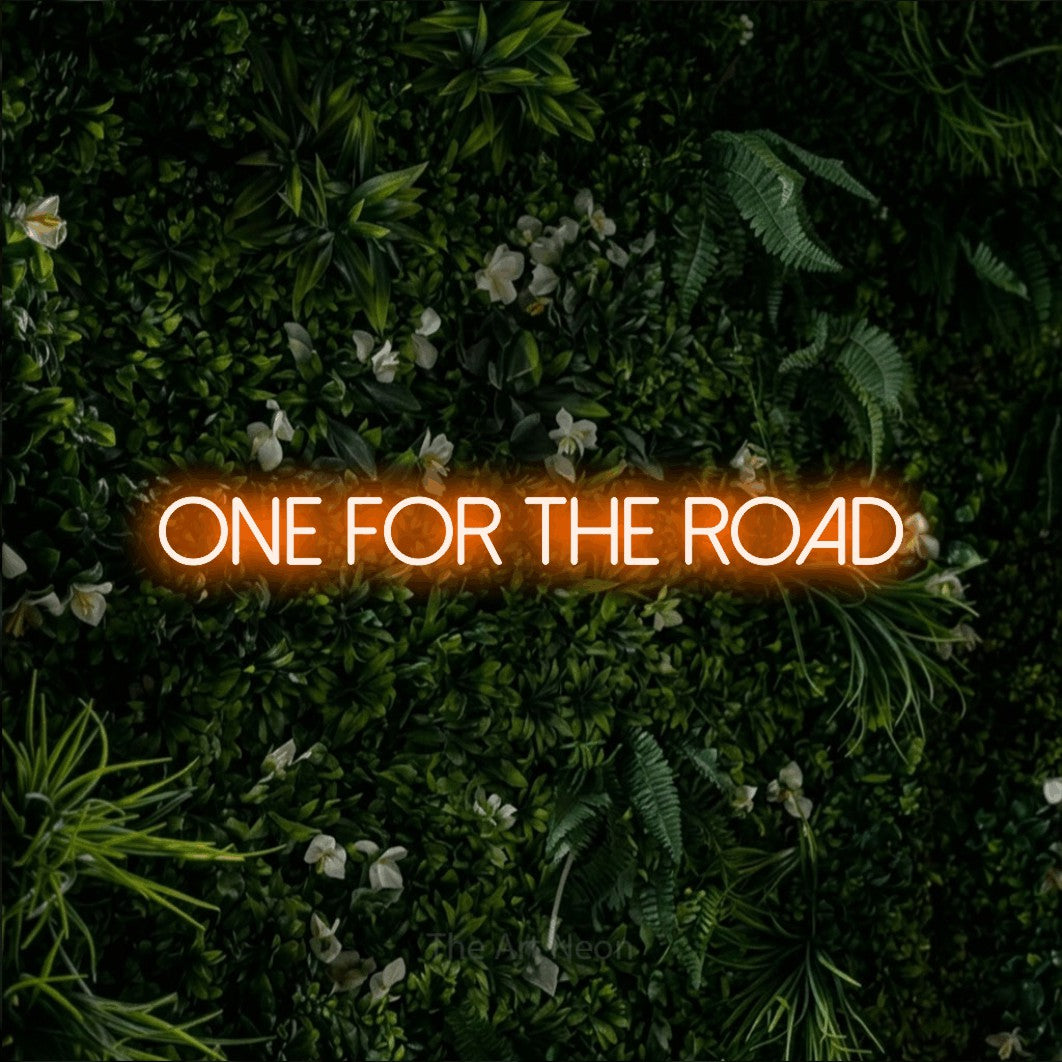 Orange LED neon sign reading "One for the Road" against a leafy green wall for bar décor