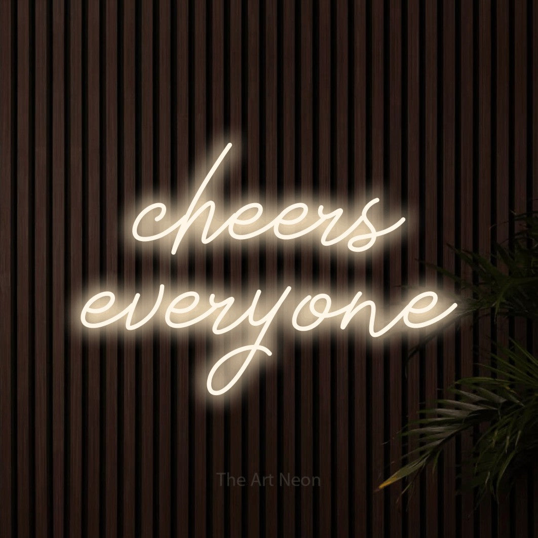 Warm white script-style LED neon sign reading "Cheers Everyone" against dark wooden slats for bar décor