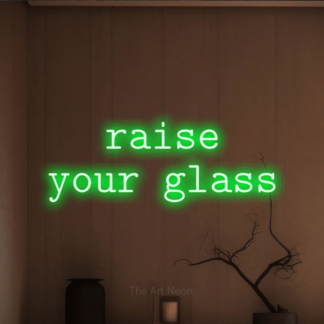 Green LED neon sign reading "Raise Your Glass" against a warm brown wall for bar décor