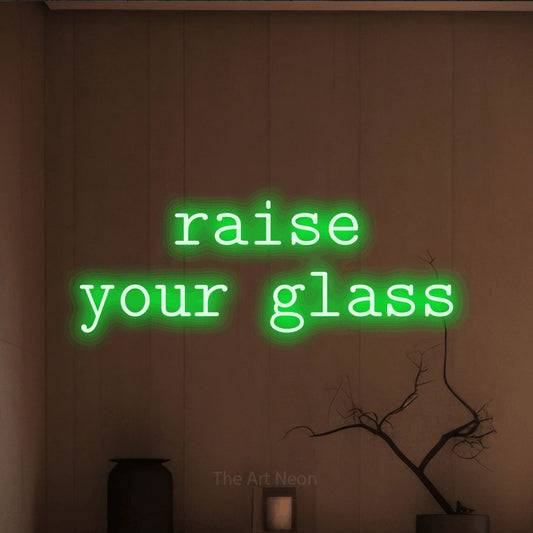 Green LED neon sign reading "Raise Your Glass" against a warm brown wall for bar décor