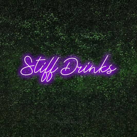 Purple script-style LED neon sign reading "Stiff Drinks" against a textured green moss wall for bar décor