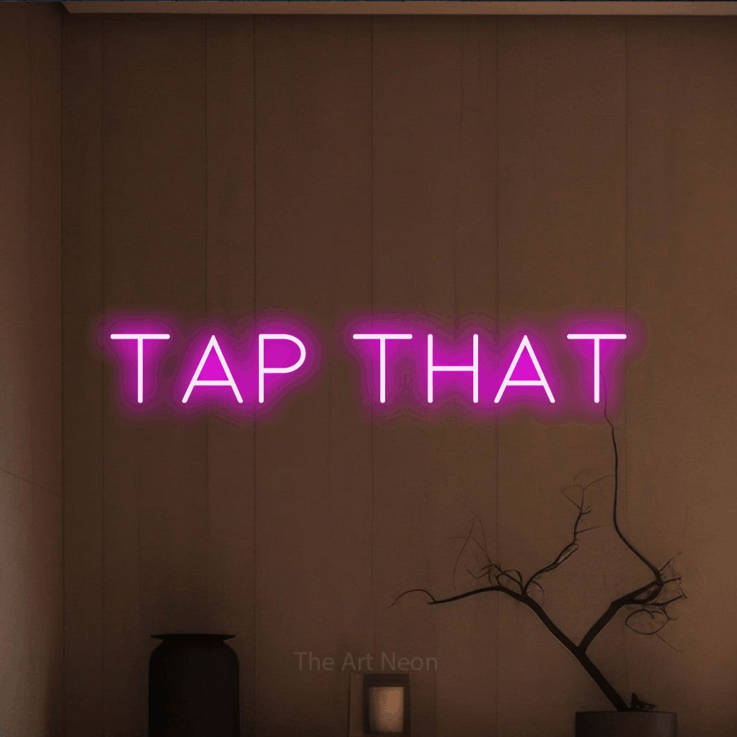 Pink LED neon sign reading "Tap That" against a warm brown wall for bar décor