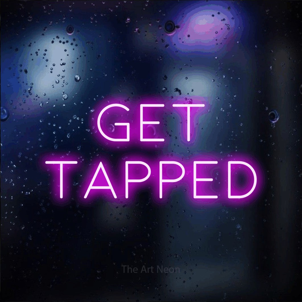 Pink LED neon sign reading "Get Tapped" against a dark blue bokeh background for bar décor