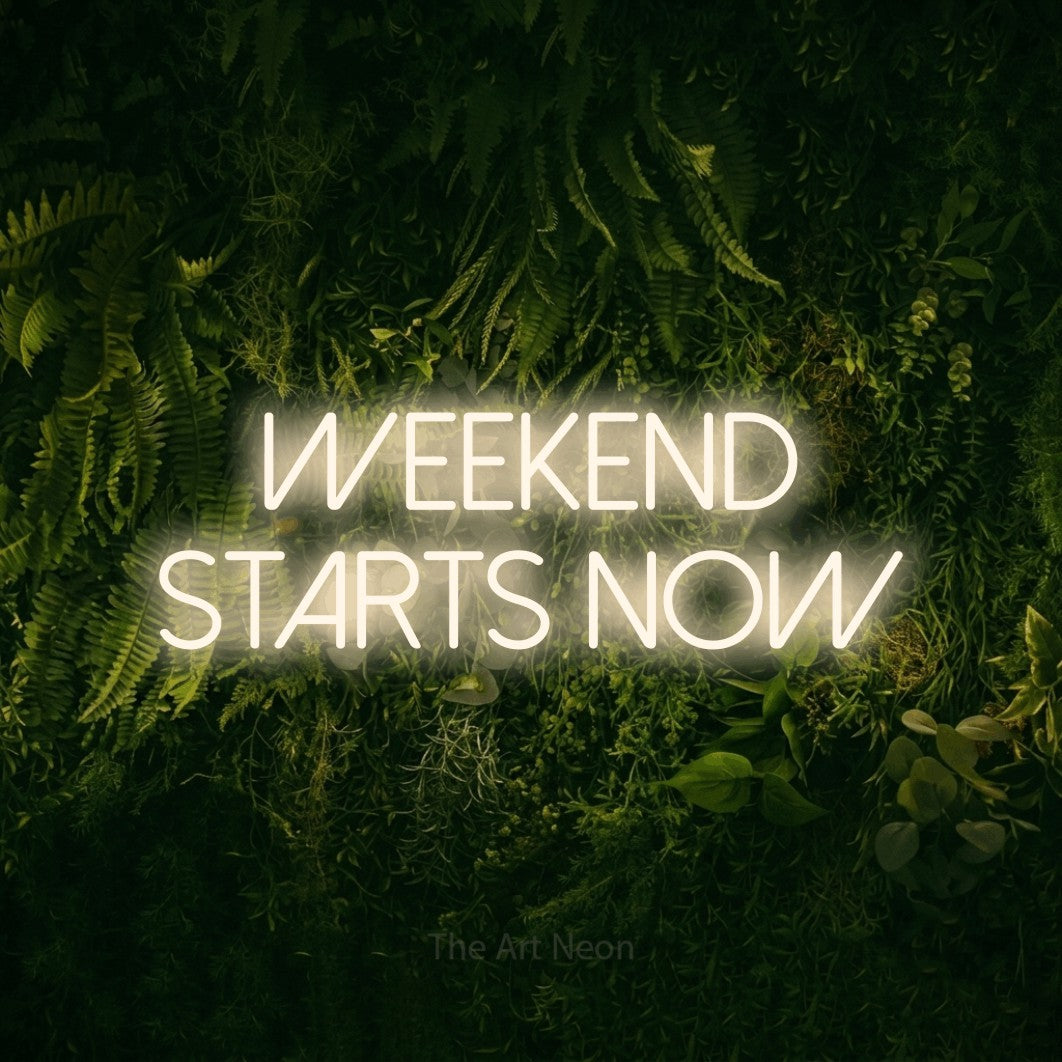 Warm white LED neon sign reading "Weekend Starts Now" against a moss-covered green wall for bar décor