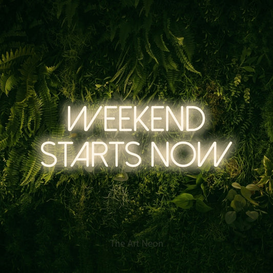 Warm white LED neon sign reading "Weekend Starts Now" against a moss-covered green wall for bar décor