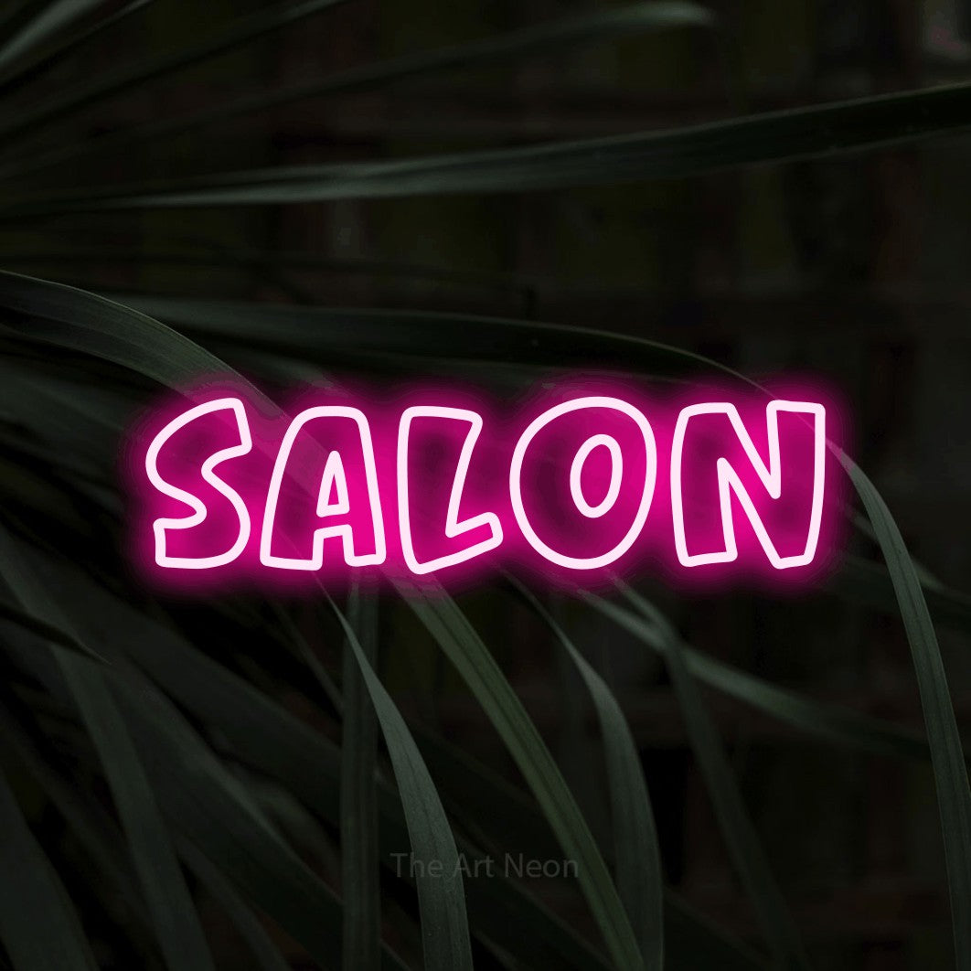 Hot pink outline-style LED neon sign reading "Salon" against dark tropical leaves for salon décor