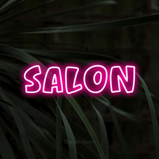 Hot pink outline-style LED neon sign reading "Salon" against dark tropical leaves for salon décor