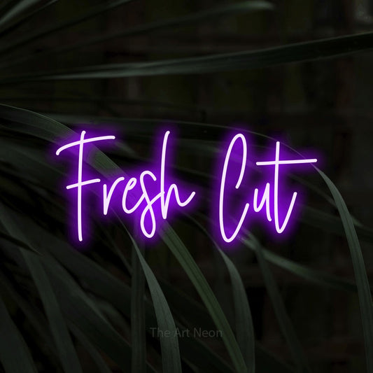 Purple script-style LED neon sign reading "Fresh Cut" against dark tropical leaves for salon décor