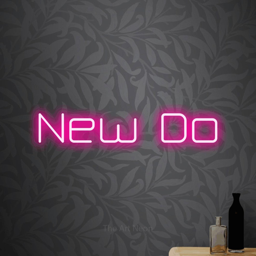 Hot pink LED neon sign reading "New Do" against light grey floral wallpaper for salon décor