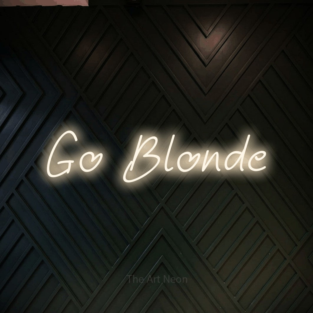 Warm white LED neon sign reading "Go Blonde" against a dark geometric wood wall for salon décor