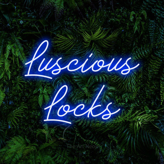 Blue script-style LED neon sign reading "Luscious Locks" against a dense tropical foliage wall for salon décor