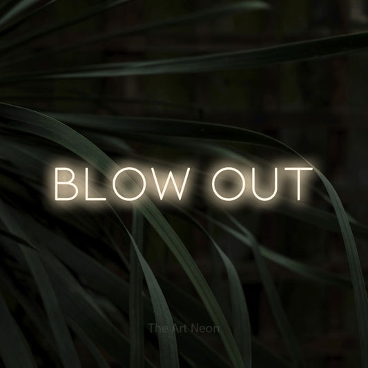 Warm white LED neon sign reading "Blow Out" against dark tropical leaves for salon décor
