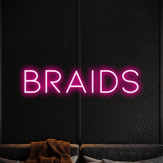 Hot pink LED neon sign reading "Braids" against a black textured wall for salon décor