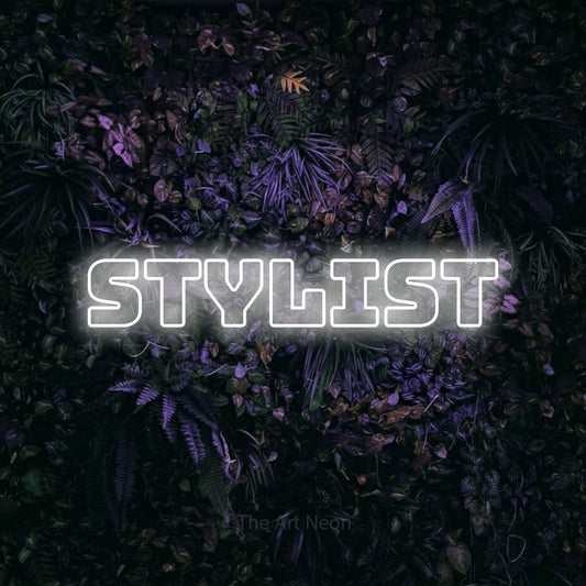 Cool white outline-style LED neon sign reading "Stylist" against a purple floral wall for salon décor