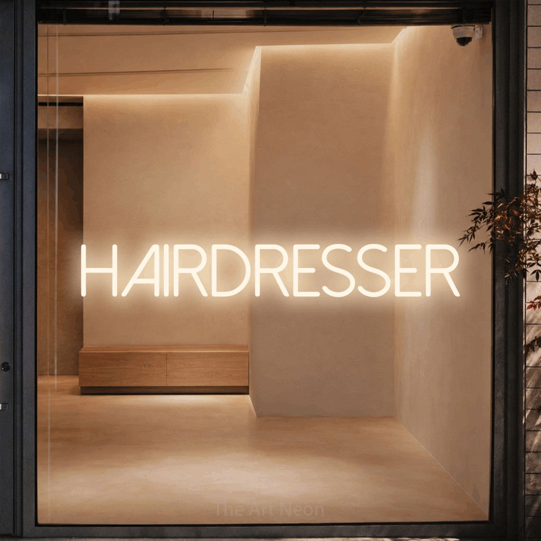 Warm white LED neon sign reading "Hairdresser" against a warm beige alcove wall for salon décor