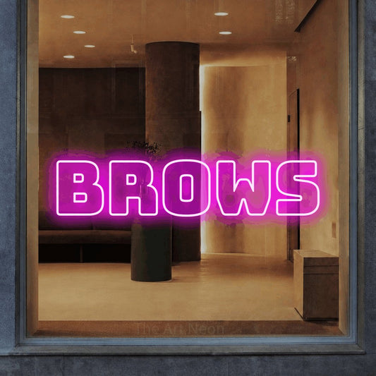 Pink outline-style LED neon sign reading "Brows" in a warm modern interior for salon décor