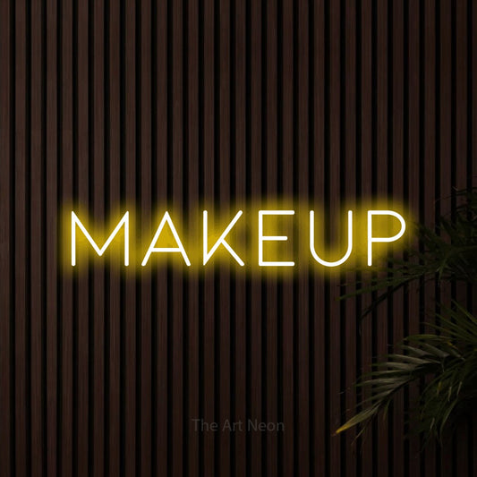 Yellow LED neon sign reading "Makeup" against dark wooden slats for salon décor