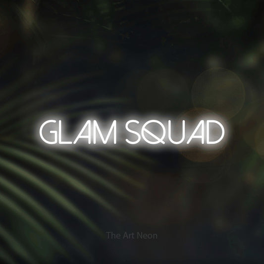 Cool white LED neon sign reading "Glam Squad" against dark blurred palm leaves for salon décor