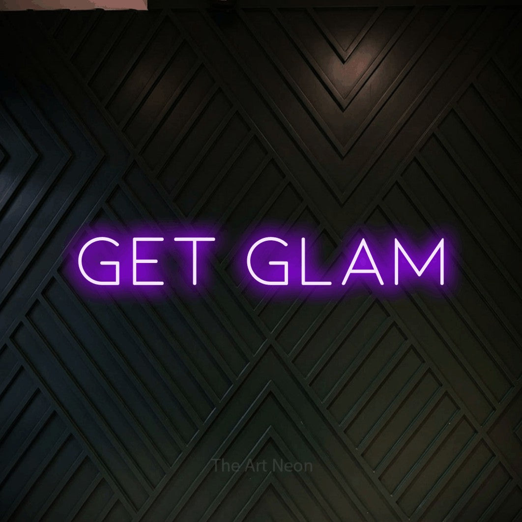 Purple LED neon sign reading "Get Glam" against a dark geometric wood wall for salon décor