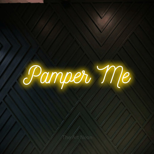 Yellow script-style LED neon sign reading "Pamper Me" against a dark geometric wood wall for salon décor
