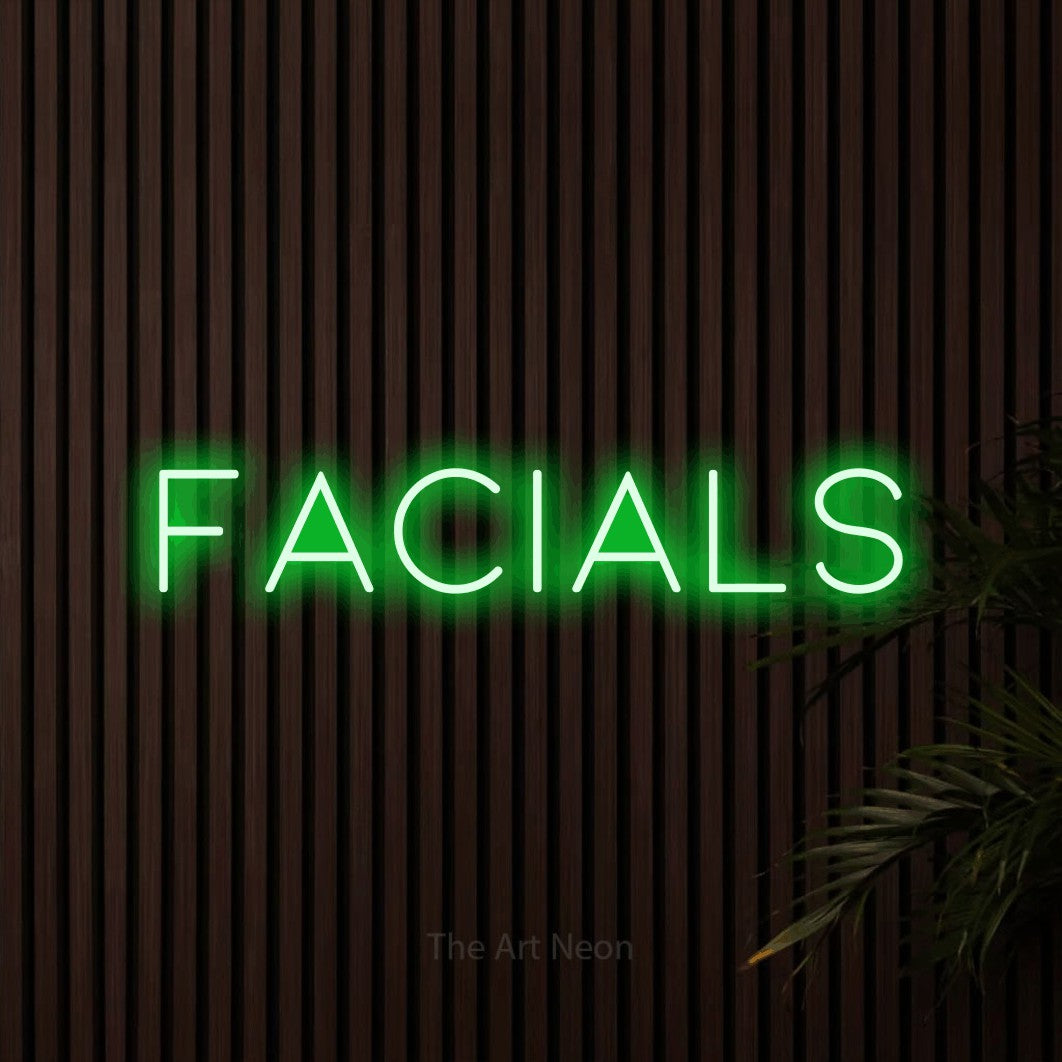 Green LED neon sign reading "Facials" against dark wooden slats for salon décor