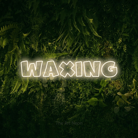 Warm white outline-style LED neon sign reading "Waxing" against a moss-covered green wall for salon décor