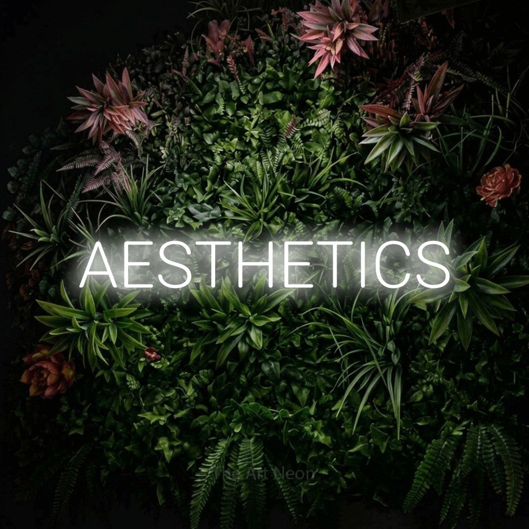 Cool white LED neon sign reading "Aesthetics" against a flowering garden wall for salon décor