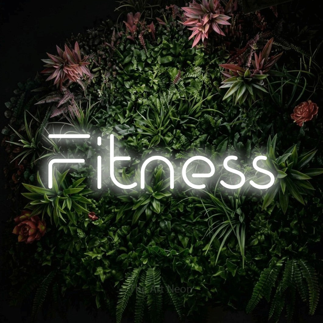 Cool white LED neon sign reading "Fitness" against a flowering garden wall for gym décor