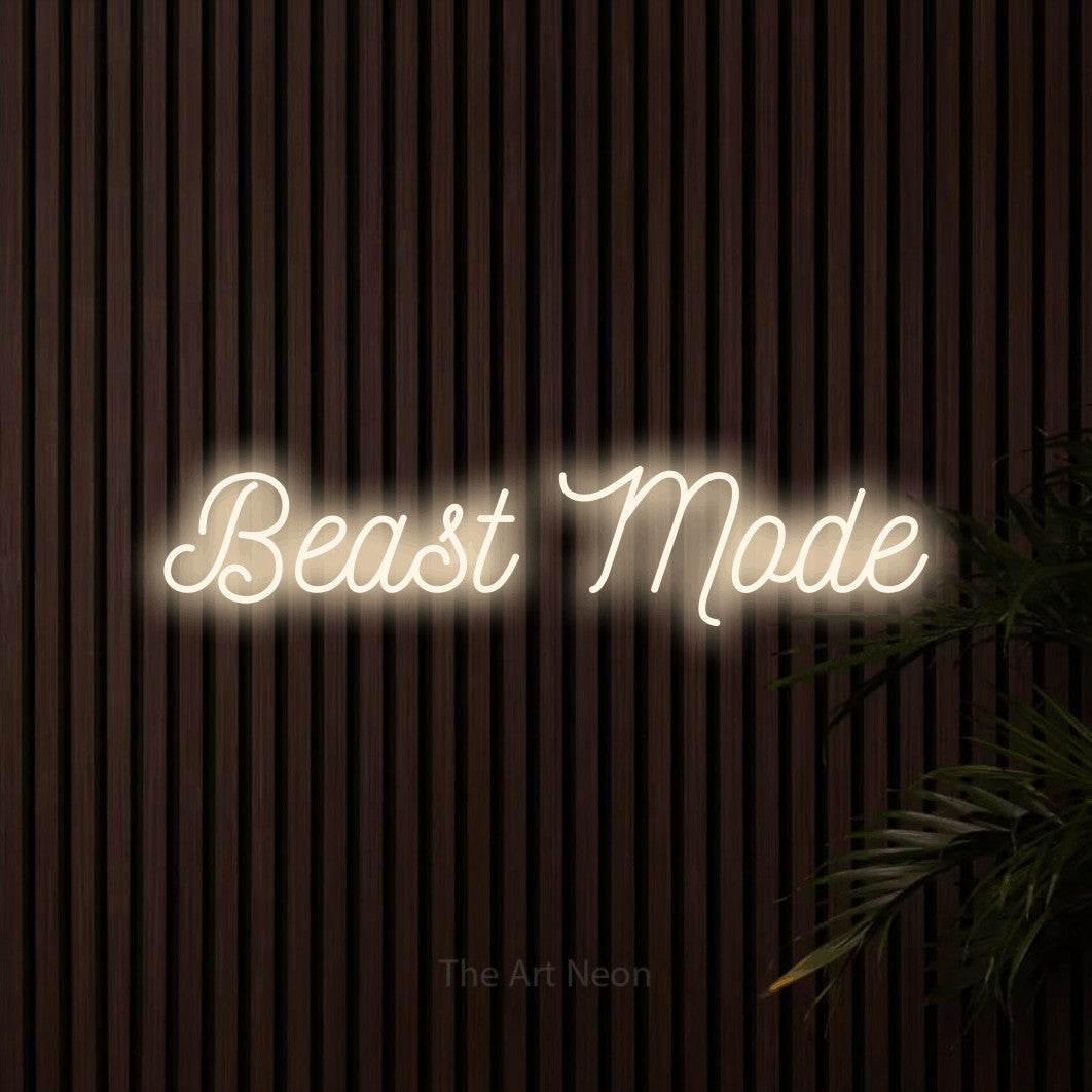 Warm white script-style LED neon sign reading "Beast Mode" against dark wooden slats for gym décor