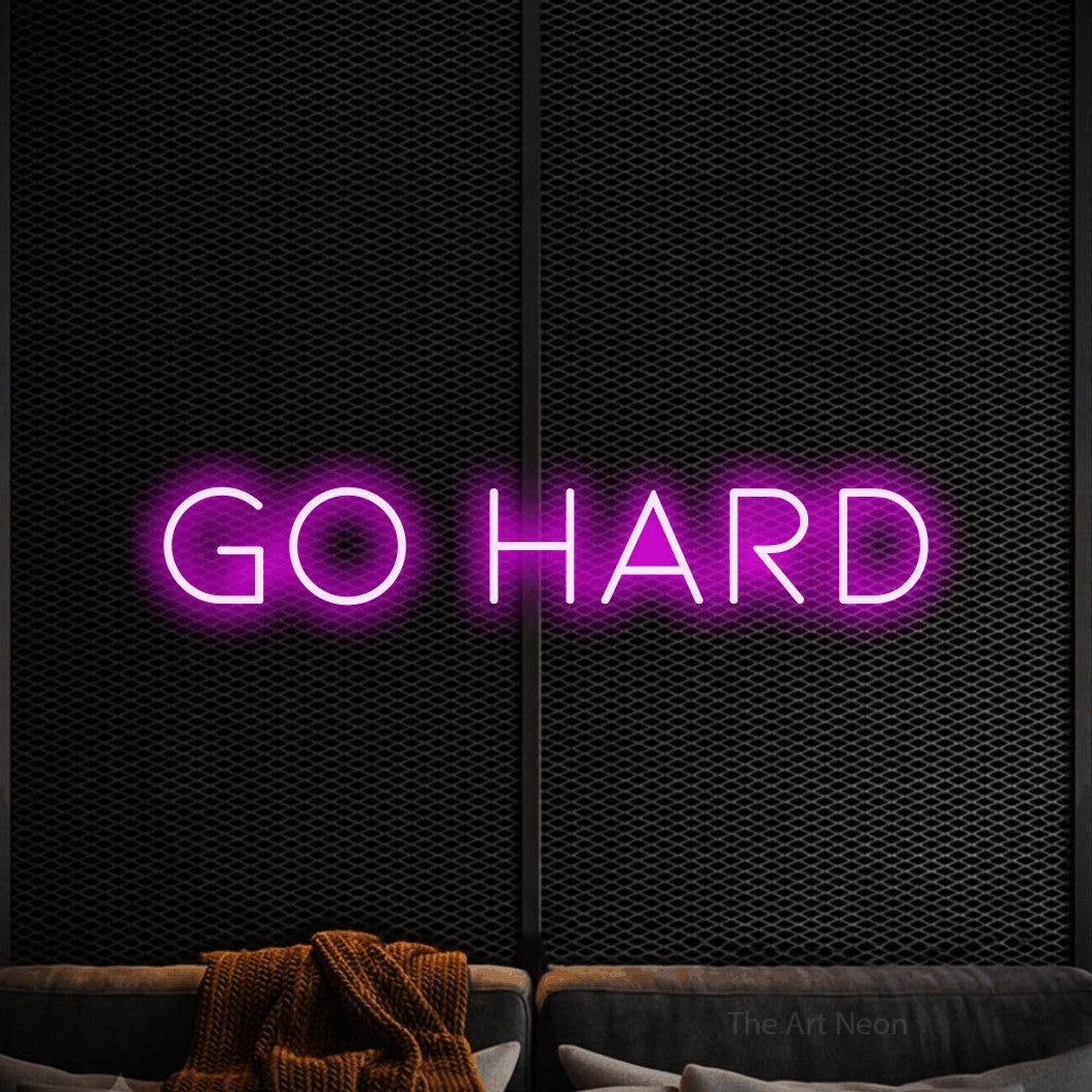Pink LED neon sign reading "Go Hard" against a black textured wall for gym décor