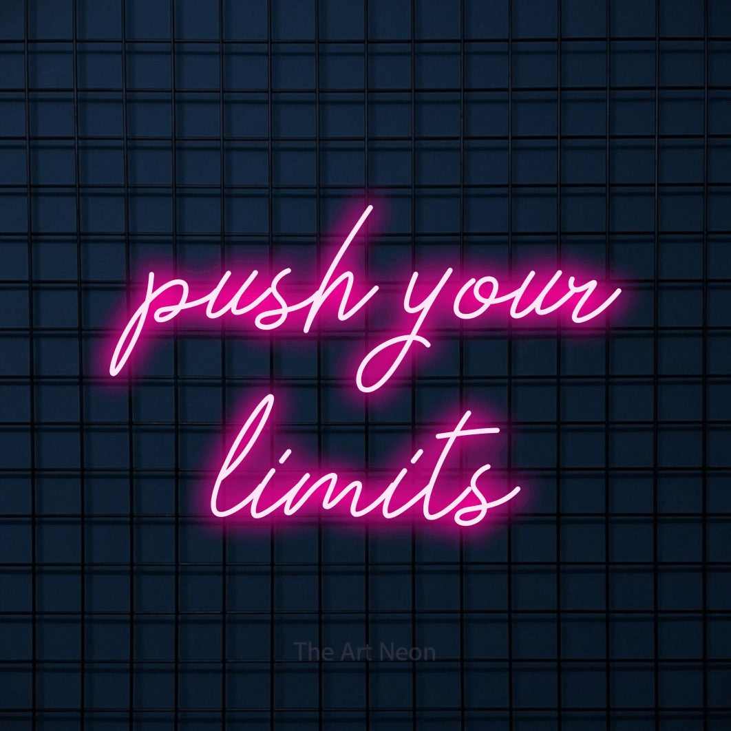 Hot pink script-style LED neon sign reading "Push Your Limits" against a dark blue tiled wall for gym décor