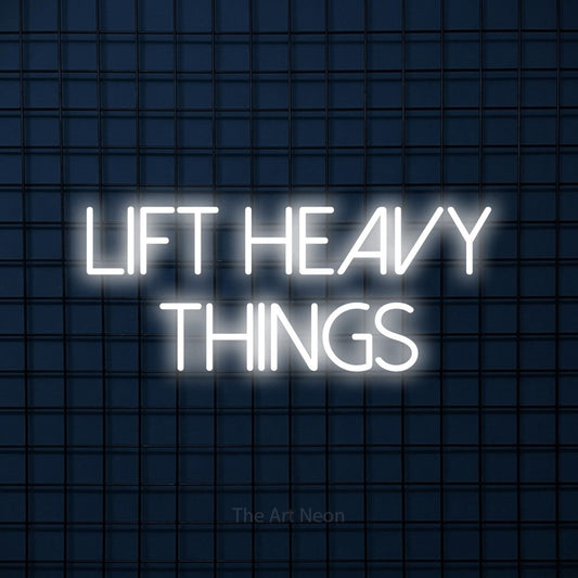 Cool white LED neon sign reading "Lift Heavy Things" against a dark blue tiled wall for gym décor