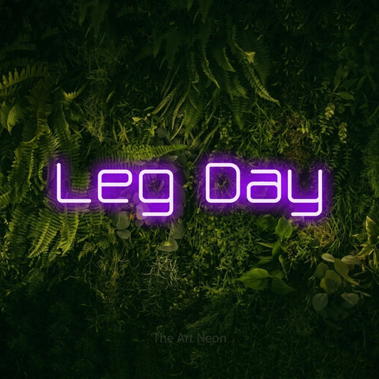 Purple LED neon sign reading "Leg Day" against a moss-covered green wall for gym décor