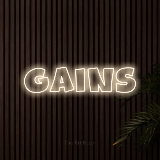 Warm white outline-style LED neon sign reading "Gains" against dark wooden slats for gym décor