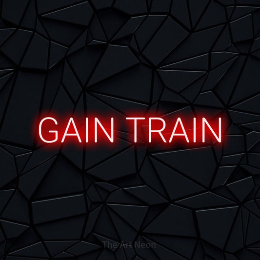 Red LED neon sign reading "Gain Train" against a black faceted wall for gym décor