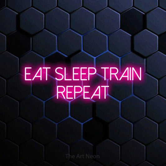 Hot pink LED neon sign reading "Eat Sleep Train Repeat" against a blue hexagonal wall for gym décor