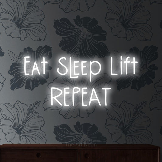 Cool white LED neon sign reading "Eat Sleep Lift Repeat" against grey floral wallpaper for gym décor