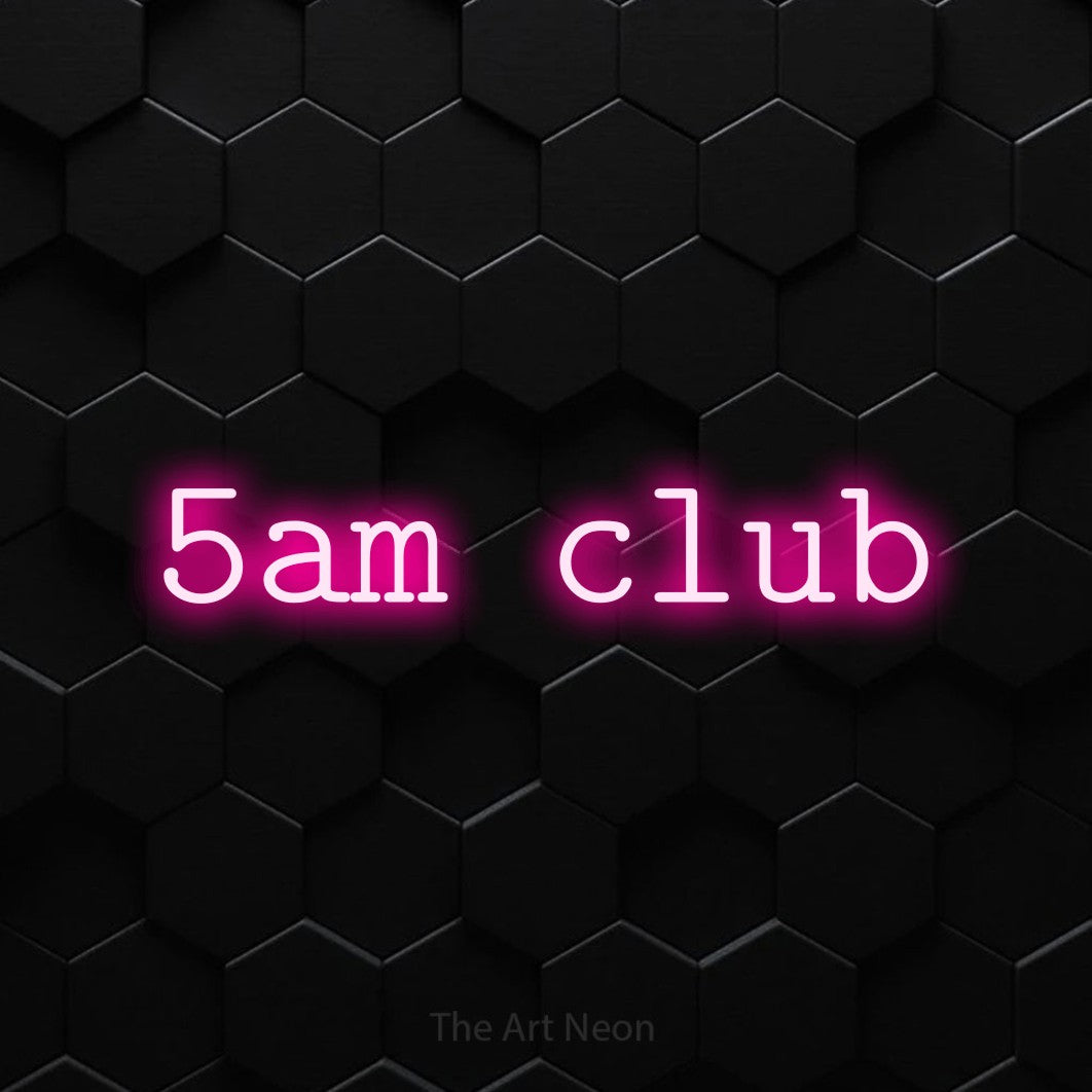 Hot pink LED neon sign reading "5AM Club" against a black hexagonal wall for gym décor