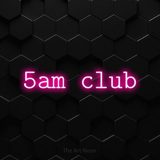 Hot pink LED neon sign reading "5AM Club" against a black hexagonal wall for gym décor
