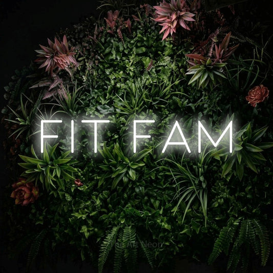 Cool white LED neon sign reading "Fit Fam" against a flowering garden wall for gym décor